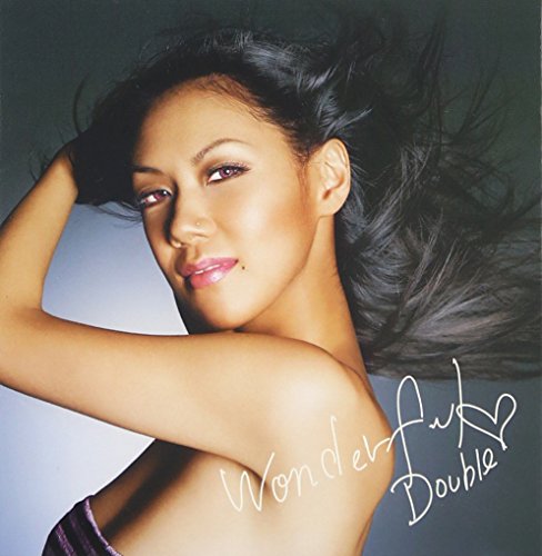 A woman with long dark hair poses against a grey background with handwritten text.