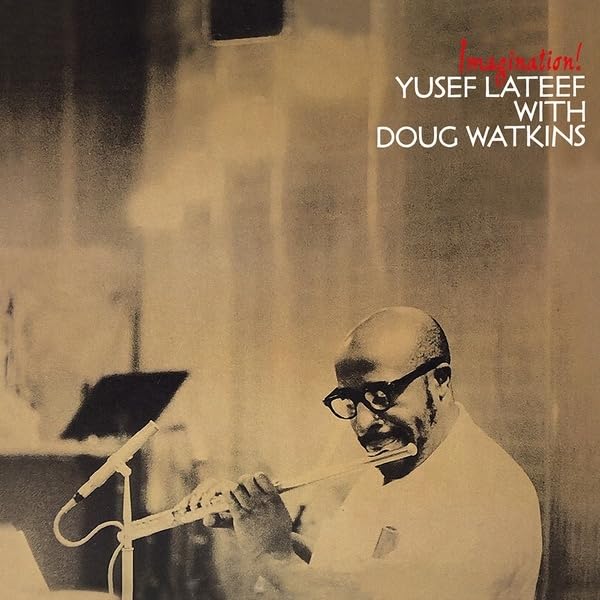 Yusef Lateef playing a flute in a recording studio, sepia tone.