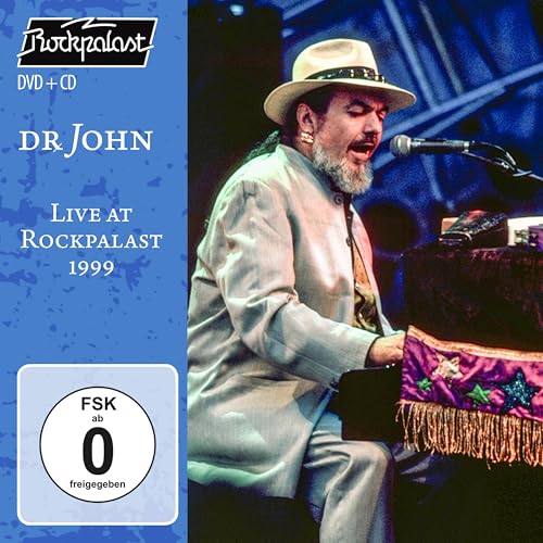 Dr. John wearing a hat and suit, playing piano on stage at Rockpalast 1999.