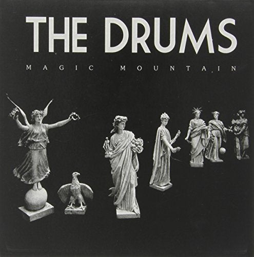 "Black vinyl record cover with white statues and 'The Drums Magic Mountain' text."