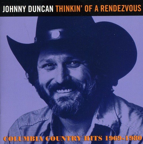 "CD cover with a man wearing a cowboy hat and smiling, purple-toned image."