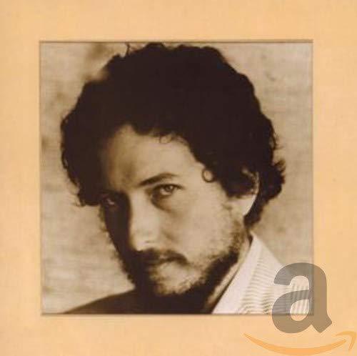 Close-up portrait of Bob Dylan with dark hair and beard.
