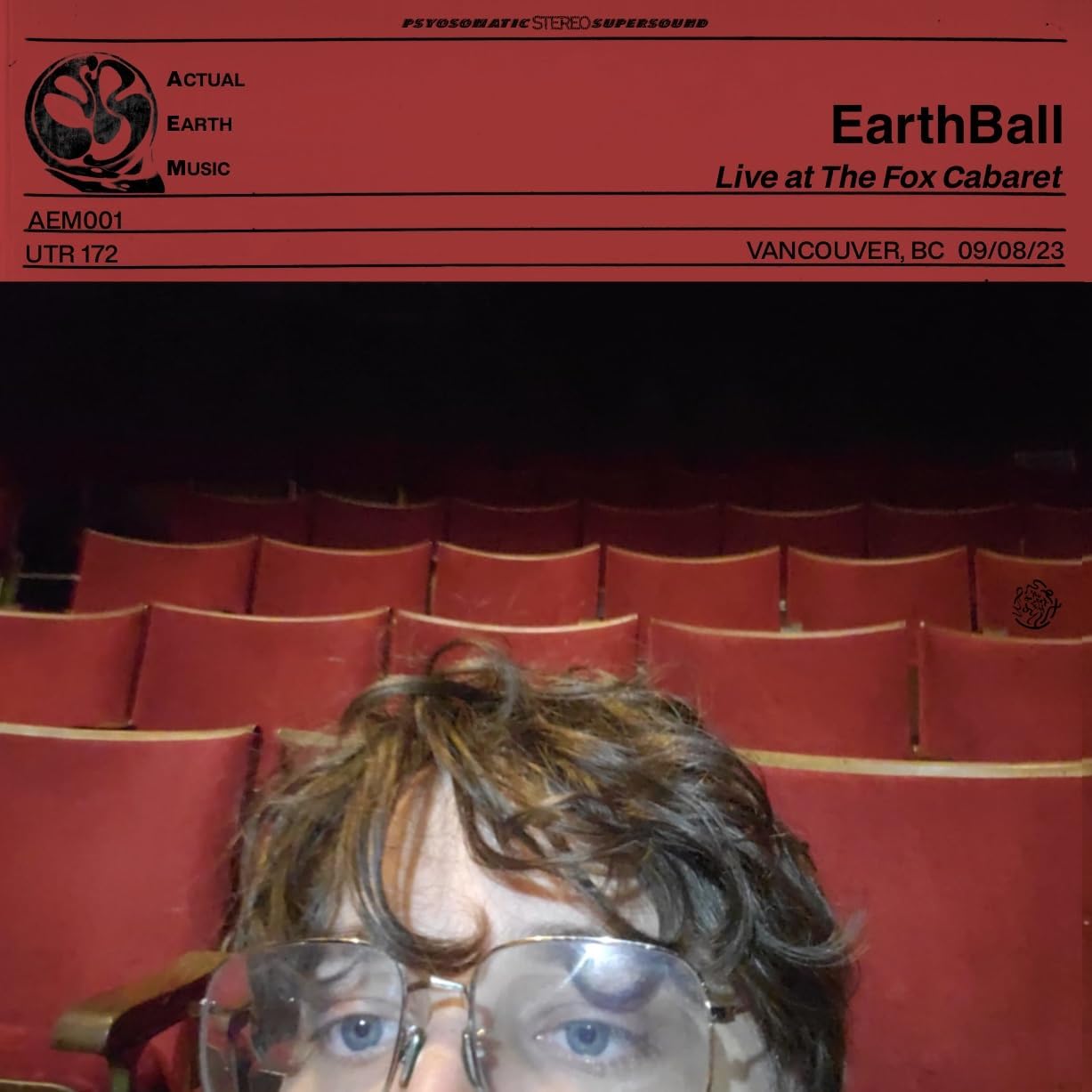Vinyl record cover with a portrait of a man with glasses and long hair.