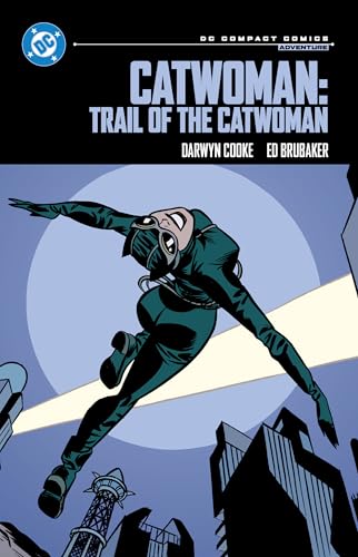 Catwoman leaps through the air against a large moon above a dark city skyline.