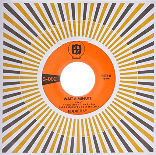 7-inch vinyl record with orange label and yellow and grey sunburst pattern sleeve.