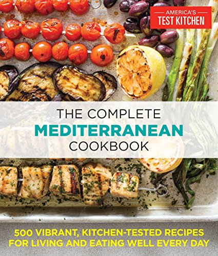 Cookbook cover featuring grilled vegetables, lemon, and skewers on a metal baking sheet.