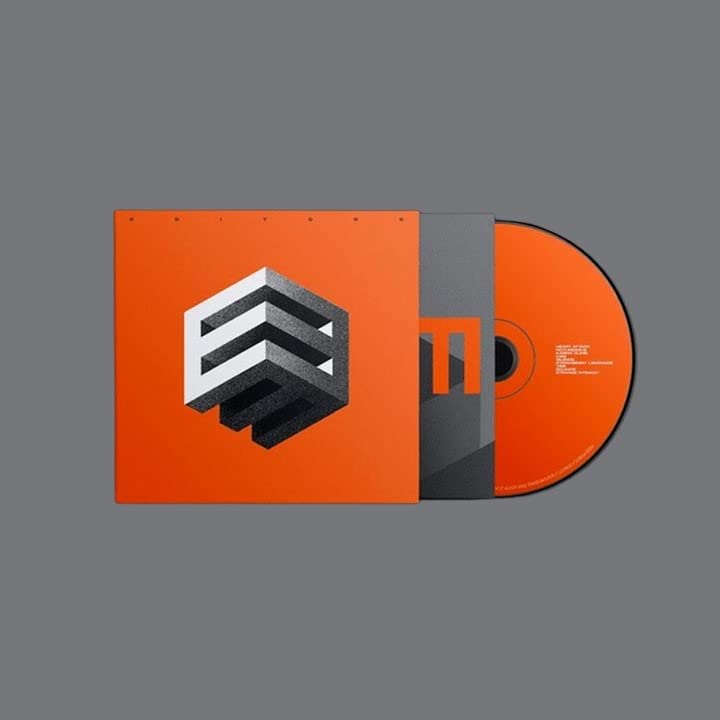 Orange CD case with geometric design and a gold-colored disc.
