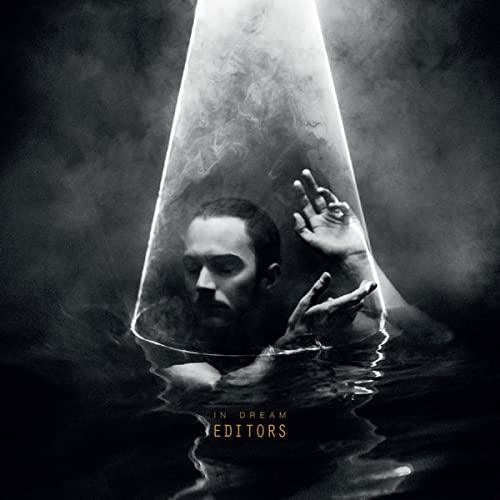 Man submerged in water under a cone, album cover for Editors’ “In Dream”.