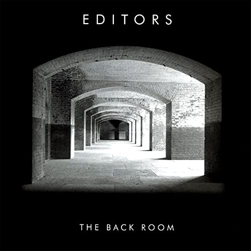 Editors album cover: a long brick archway receding into darkness.