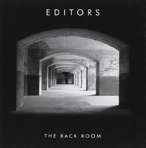 Black and white album cover with a long brick arched hallway.