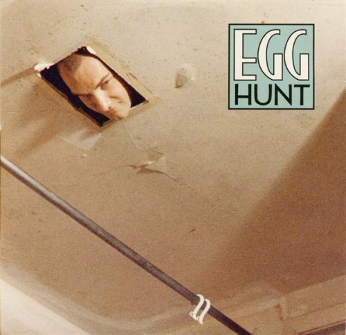 CD cover: face peering through a hole, text “EGG HUNT” right side.