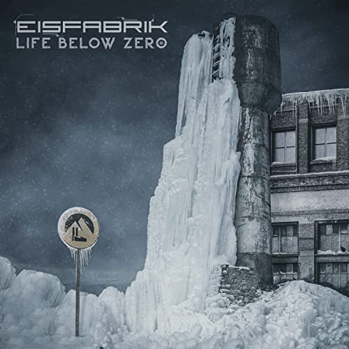 Icy industrial building with a warning sign in a snowy landscape.