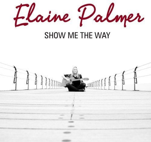 CD cover: woman with guitar on a long, empty bridge.