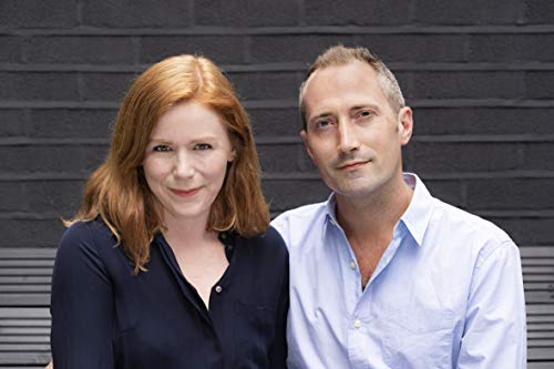 A woman with red hair and a man in a light blue shirt.