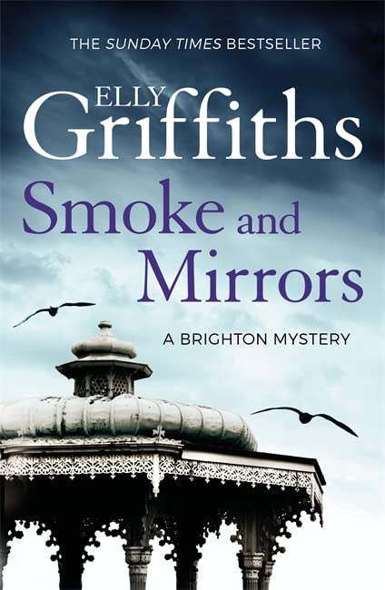 Book cover of Smoke and Mirrors featuring a Victorian bandstand under a cloudy sky.