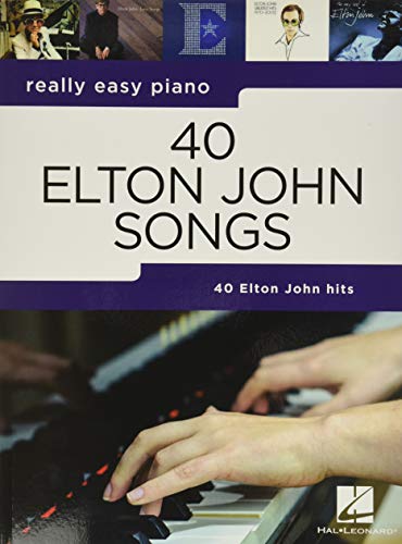 Piano songbook cover featuring Elton John and hands playing keys.