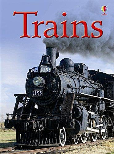 Black steam locomotive with number 1158 on the tracks, emitting smoke.