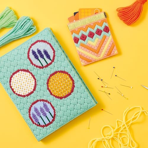 Needlepoint projects: a book cover, cardholder, and embroidery floss on yellow.