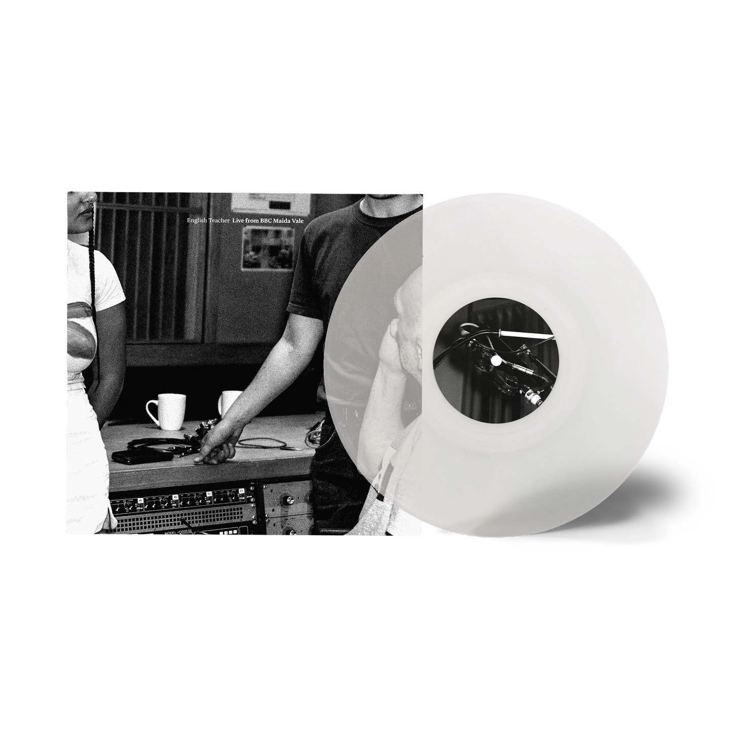 Black and white vinyl record with studio equipment and a musician.