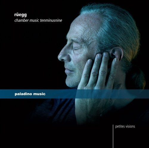 CD cover with a man touching his face against a dark background.