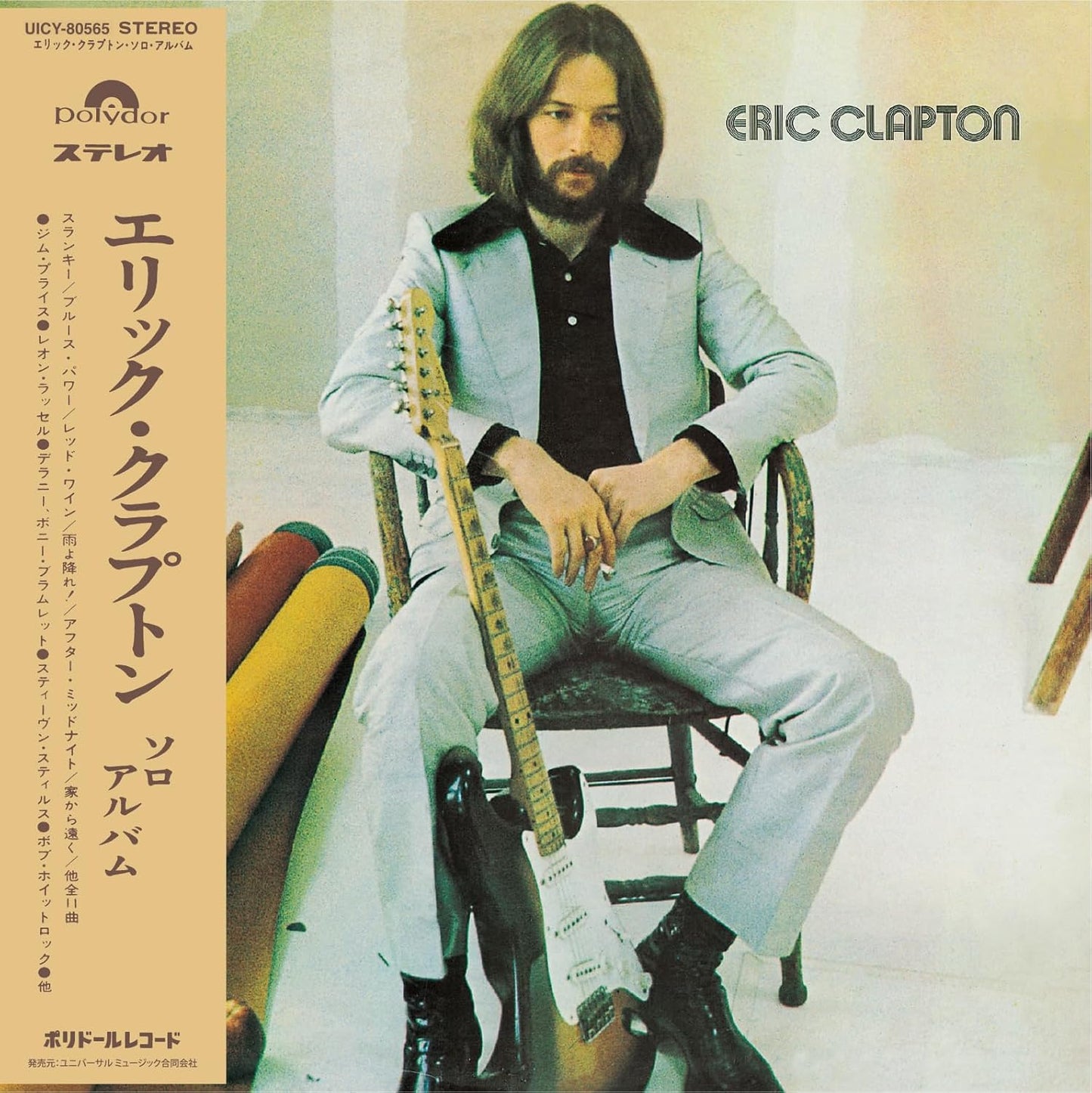 Eric Clapton album cover featuring the musician sitting with a guitar.