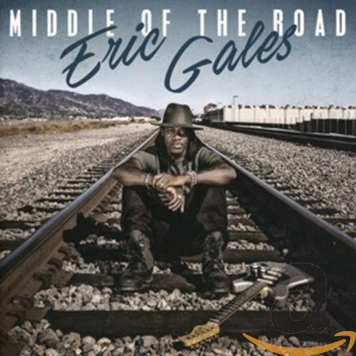 Eric Gales sitting on railroad tracks with a guitar, album cover art.