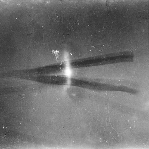 Abstract grayscale image with two blurred, intersecting lines and light flare.