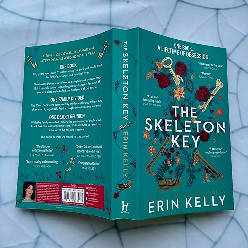 Open book, “The Skeleton Key,” with teal cover and floral illustrations.