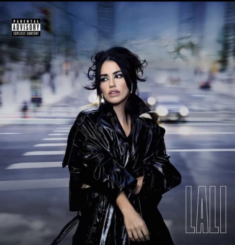 Lali album cover featuring a woman in a black jacket, city background.