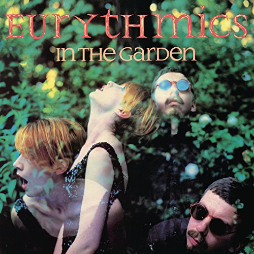 "Eurythmics' album cover featuring four band members surrounded by foliage."