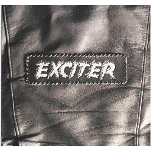 Close-up of a black and white patch reading "EXCITER" on textured fabric.