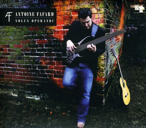 Antoine Fafard with a bass guitar, album cover with brick wall.
