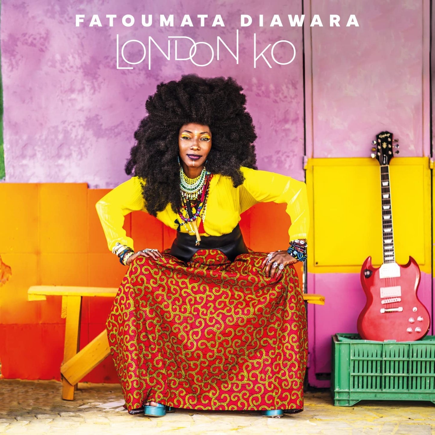 Fatoumata Diawara album cover, woman with guitar, colorful clothing.