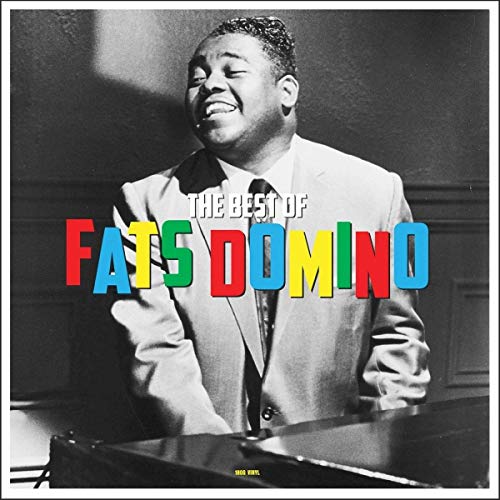 Black and white portrait of Fats Domino playing piano with colorful text overlay.