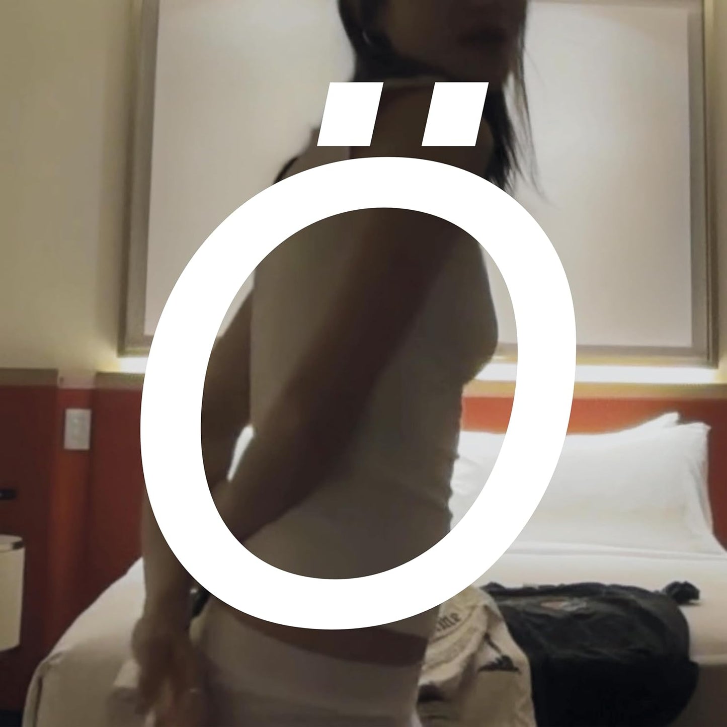 CD cover with a person’s back and a large white circle symbol.