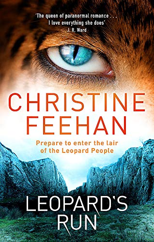 Book cover: close-up of a blue leopard eye over mountains.