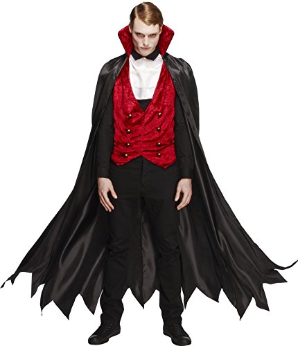 Man dressed as a vampire in a red waistcoat, black cape, and formal attire.