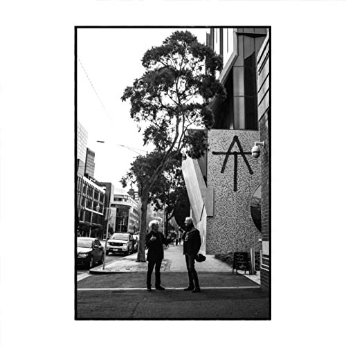 Black and white CD cover featuring two people on a city street.