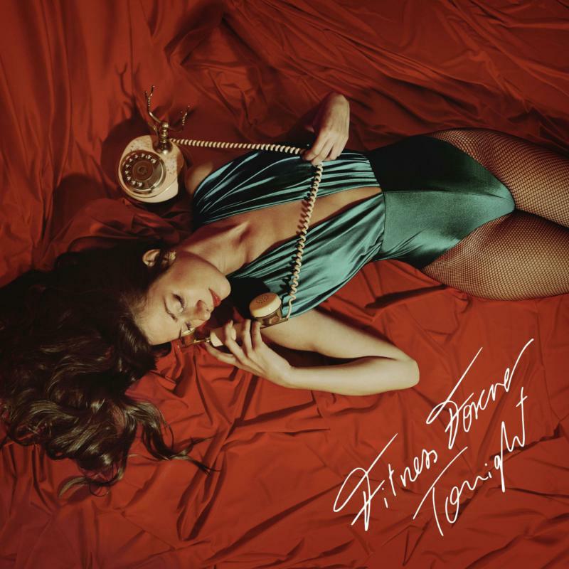 Woman with telephone on red bedding, album cover for "Tonight" vinyl.
