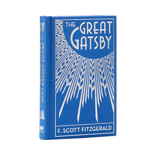 Blue hardcover book of The Great Gatsby with silver art deco sunburst design.