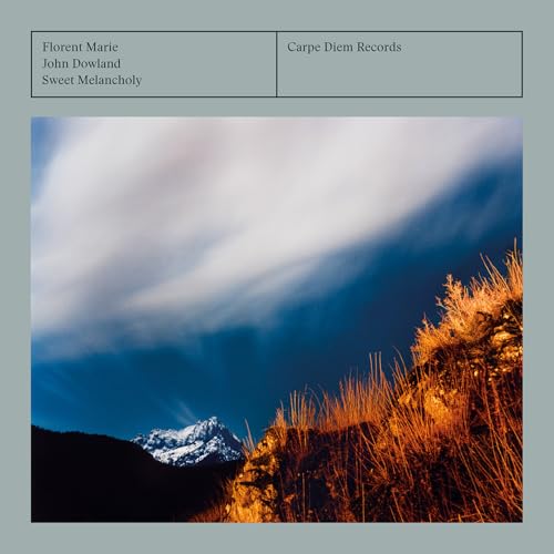CD cover with a cloudy sky over a mountainous, grassy landscape.