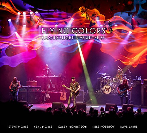 Flying Colors band performing on stage with colorful light effects.