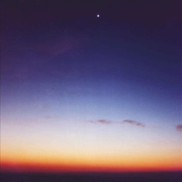 A gradient sky transitioning from dark purple at the top to orange at the horizon.