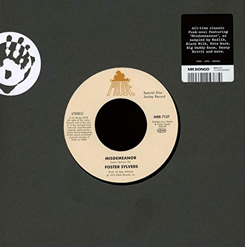 Vinyl record with beige label, black center, on dark grey background with barcode sticker.