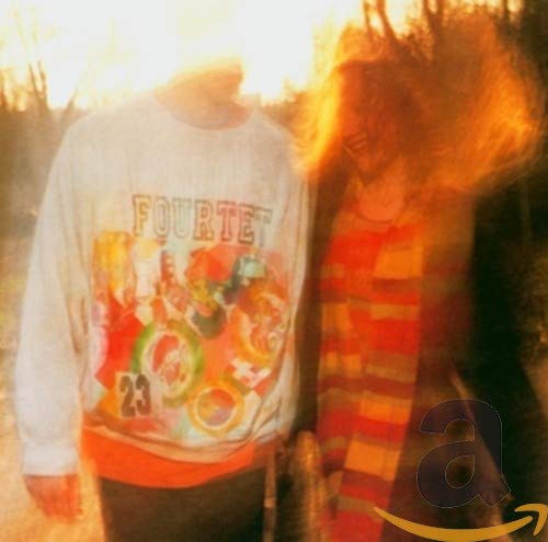 CD cover for Fourtet’s “Pause” featuring blurry figures in warm tones.