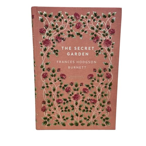 A pink hardcover book titled The Secret Garden with a floral rose vine pattern.