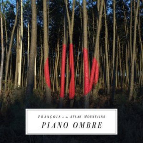 Vinyl album cover with a forest scene and red piano key shapes.