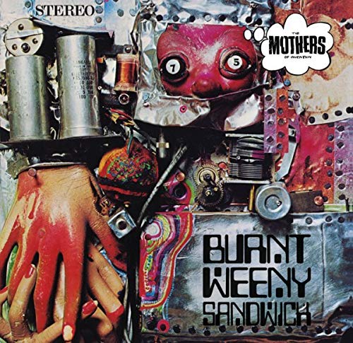 Album cover art featuring a collage of a red face, hands, and mechanical parts.