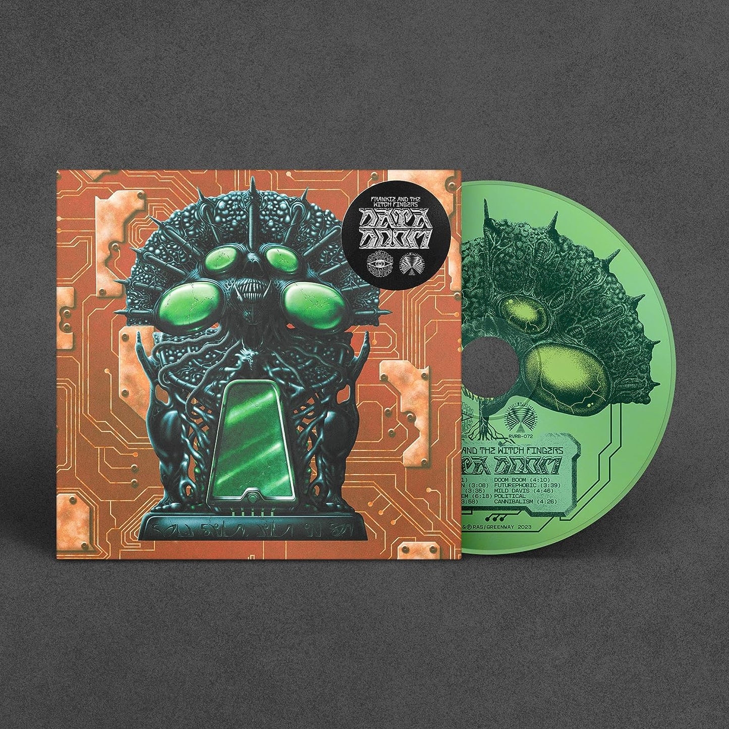 "CD case and disc with futuristic, green, robotic creature artwork against a circuit board background."