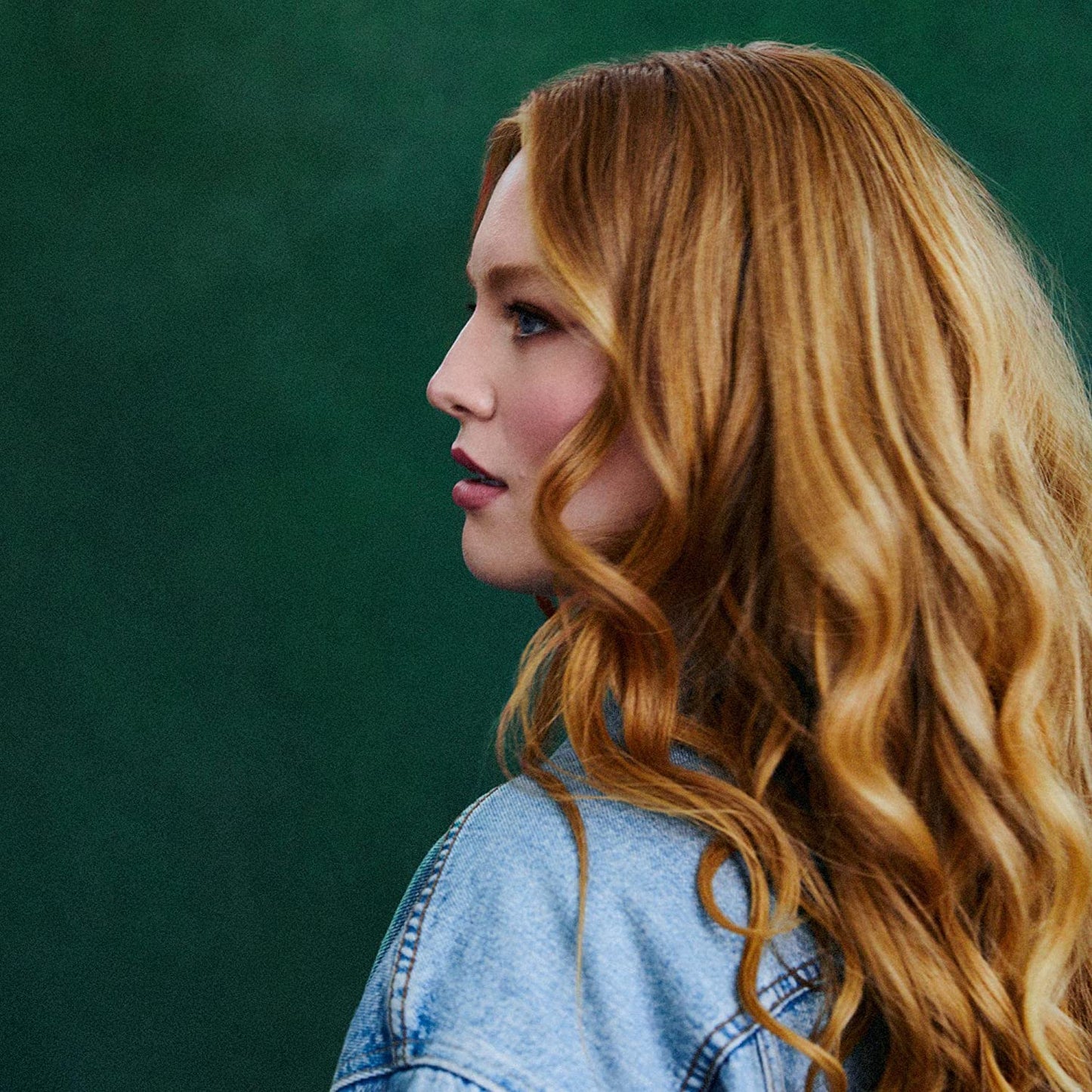 CD cover featuring a side profile of a woman with long, wavy red hair.